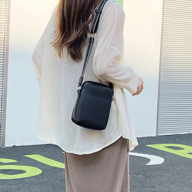Solid colour PU leather mobile phone crossbody bag showing compact size and shoulder strap.