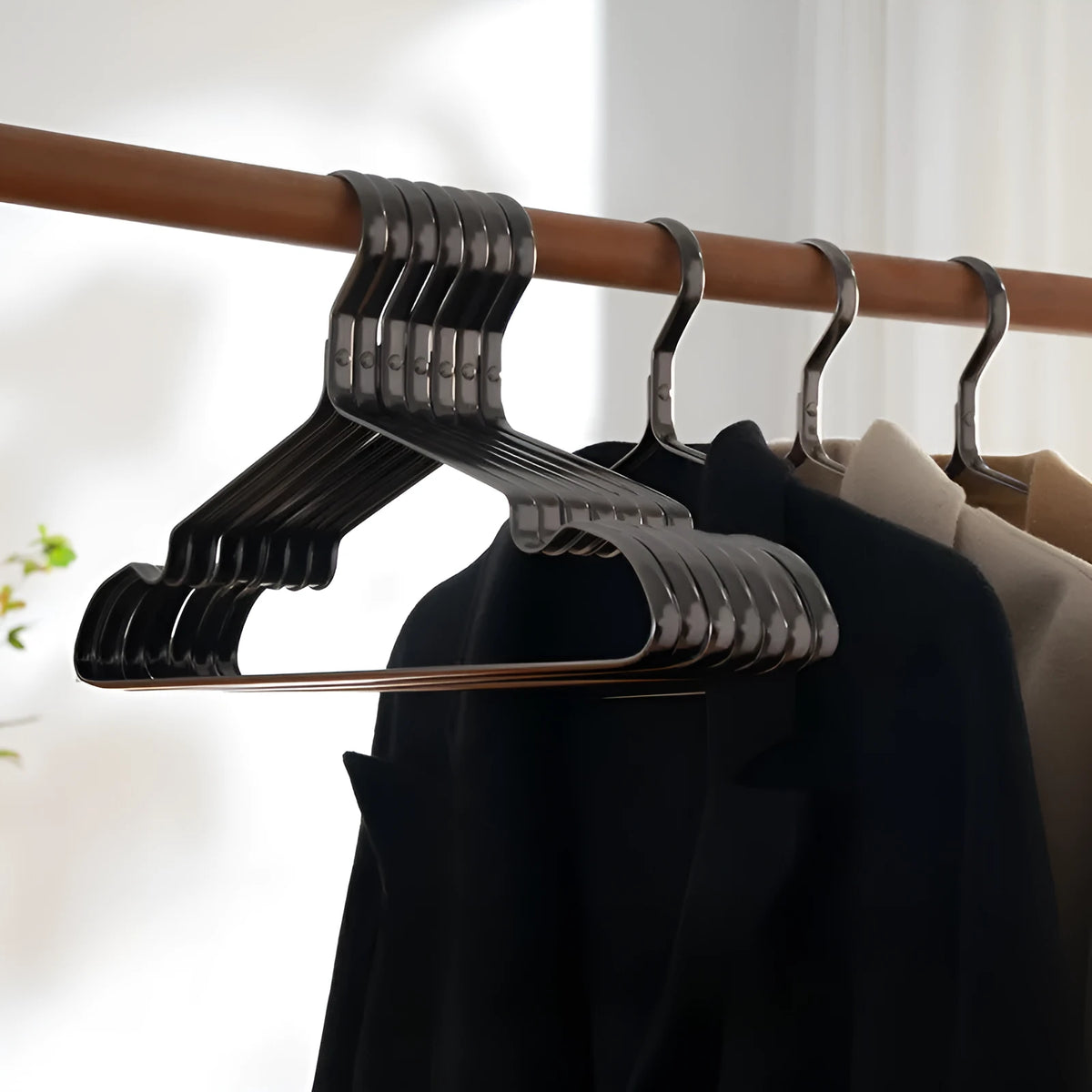 Modern elegant black non-slip clothes hanger on a white background.