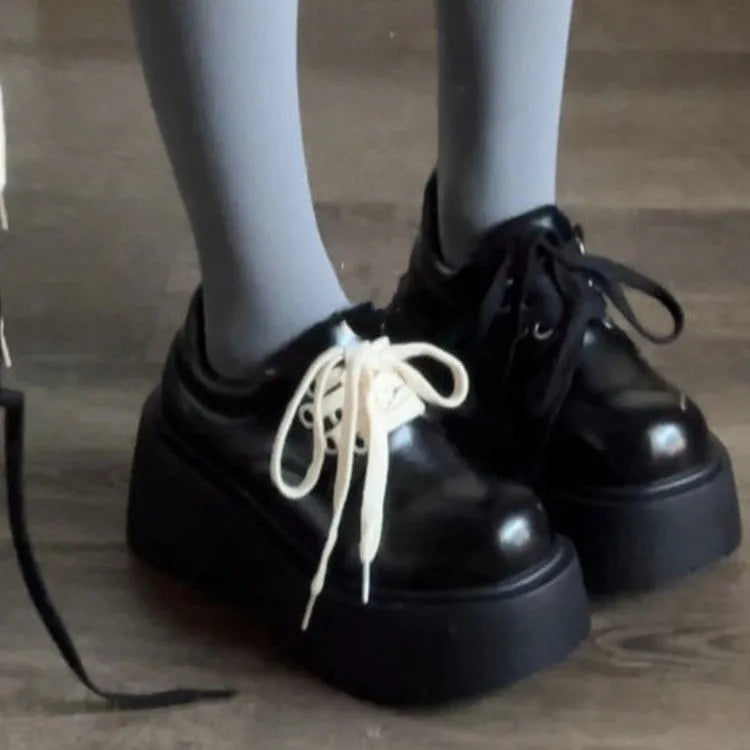 Matte black women's lace-up buckle boots with a thick sole and 6-8cm chunky heel on a white background.