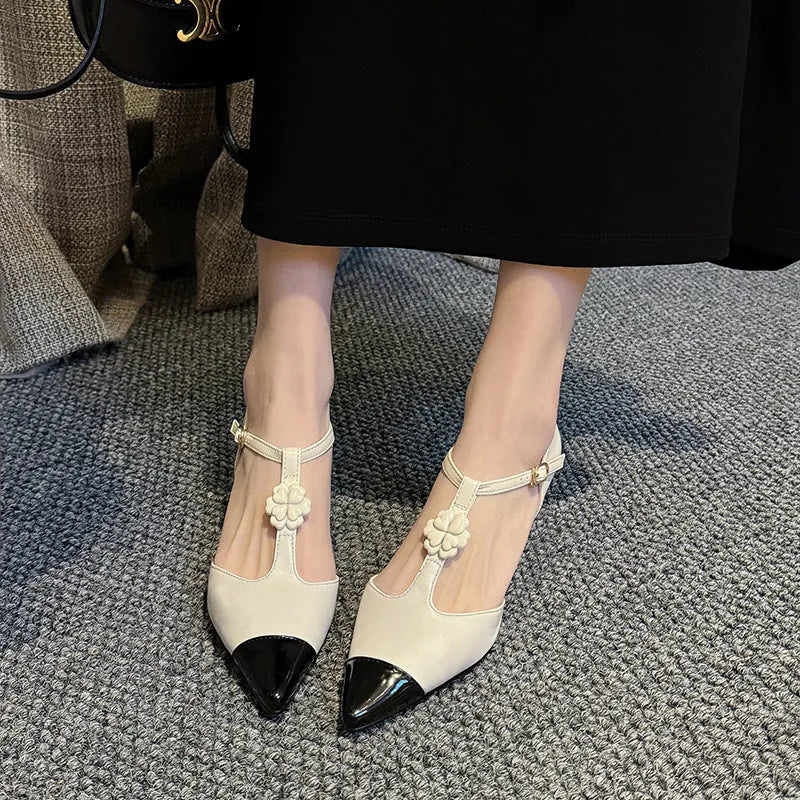 Women's pointed toe stiletto shoes with decorative flowers and buckles in black, gold, and milky white colours