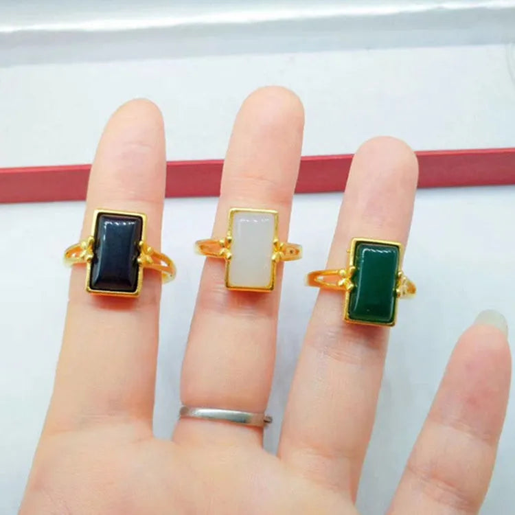 Adjustable brass gold-plated ring with a coloured gemstone in a national style design.