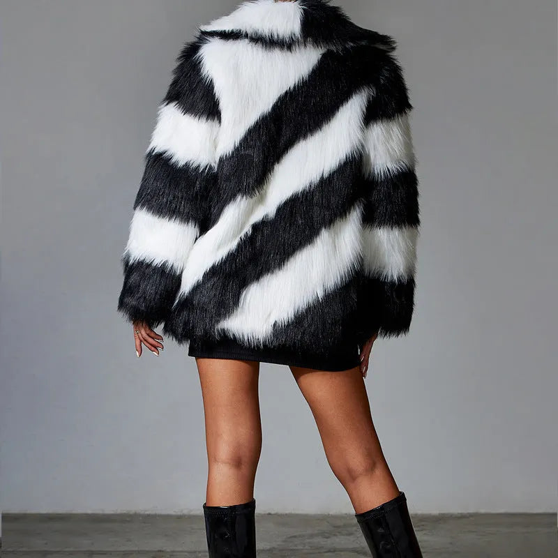 Women's faux fur coat with dark contrast lapels and a light fur collar.