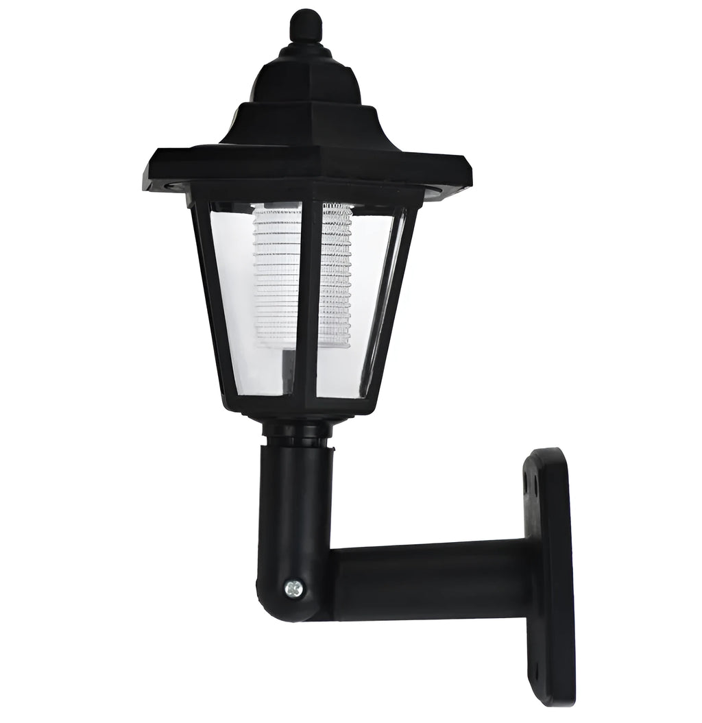 Black hexagonal solar-powered wall lamp for outdoor garden use, shown mounted on a fence