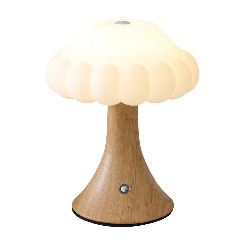 Wood grain coloured mushroom-shaped touch night lamp on a wooden table.