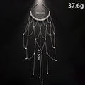 Women's gold and pearl mesh tassel hair chain fashion accessory on white background.