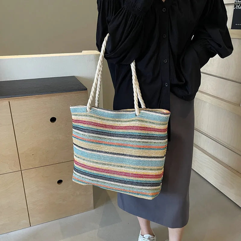 Blue straw woven large capacity single shoulder bag with nylon exterior and polyester lining.