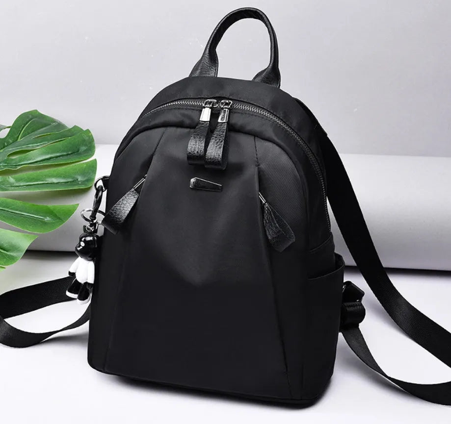Medium grey Oxford cloth rucksack with double shoulder straps and front digging pocket.