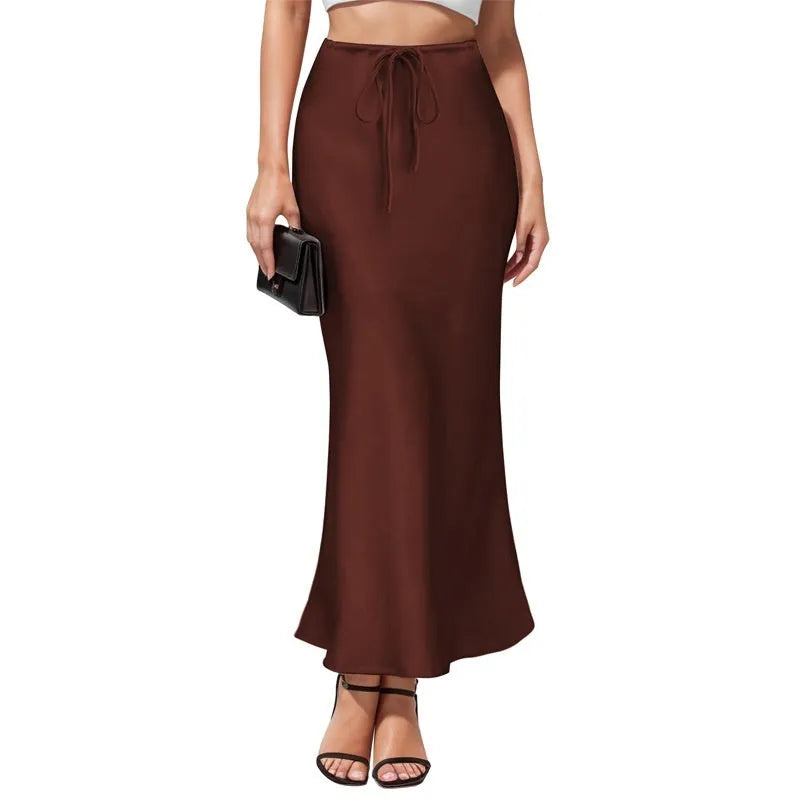 Women's high-waist asymmetric satin skirt in black with irregular stitching detail.