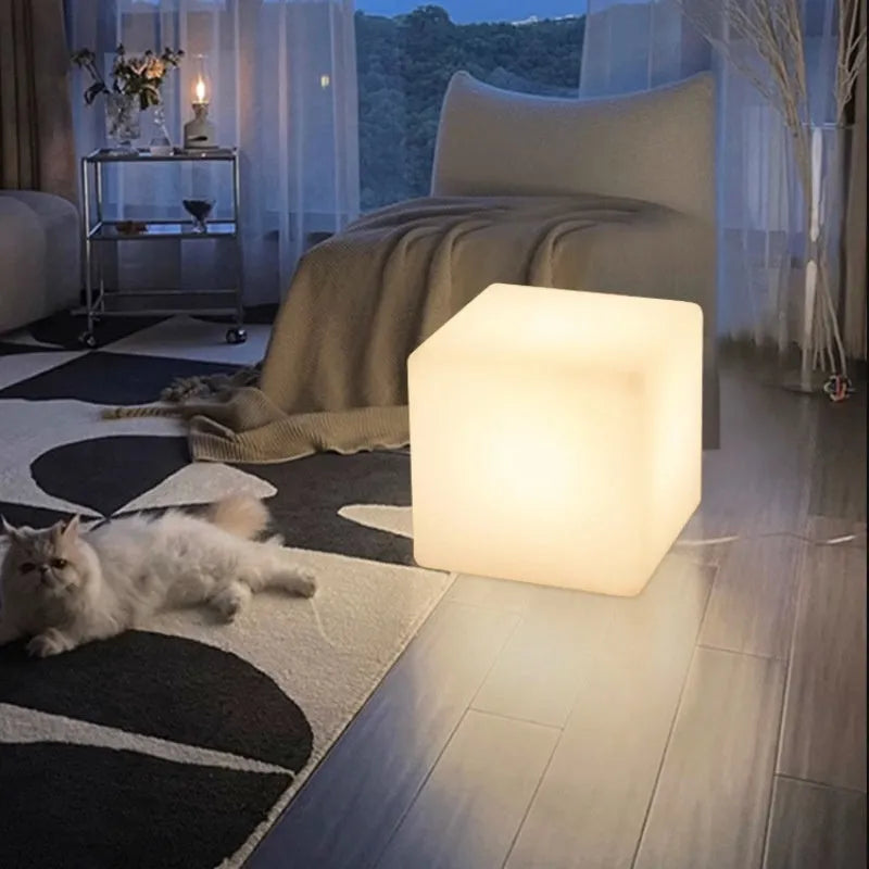 Modern white LED cube stool light outdoors, showing clean square design and soft illumination.
