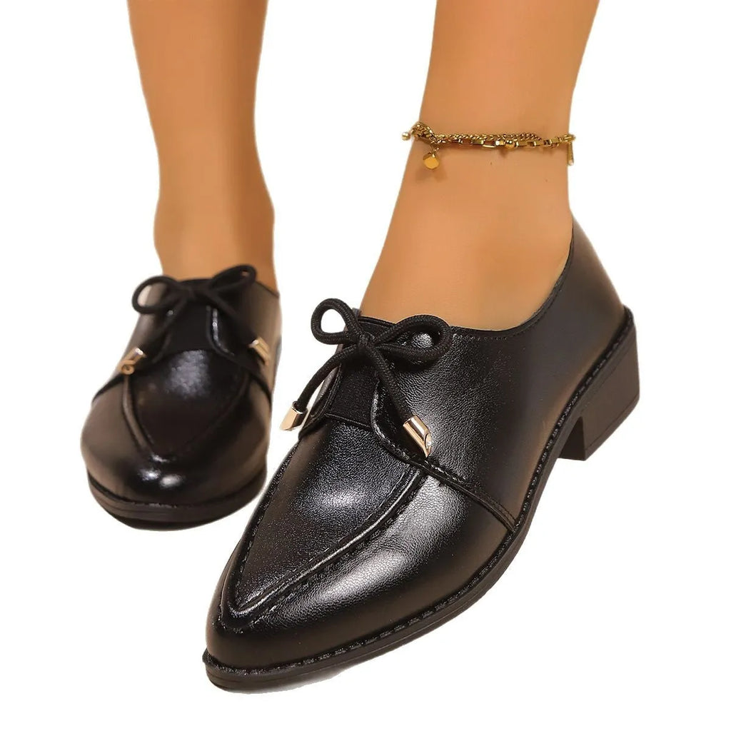 Women's British-style flat shoes with bow detail, pointed toe, and rubber sole