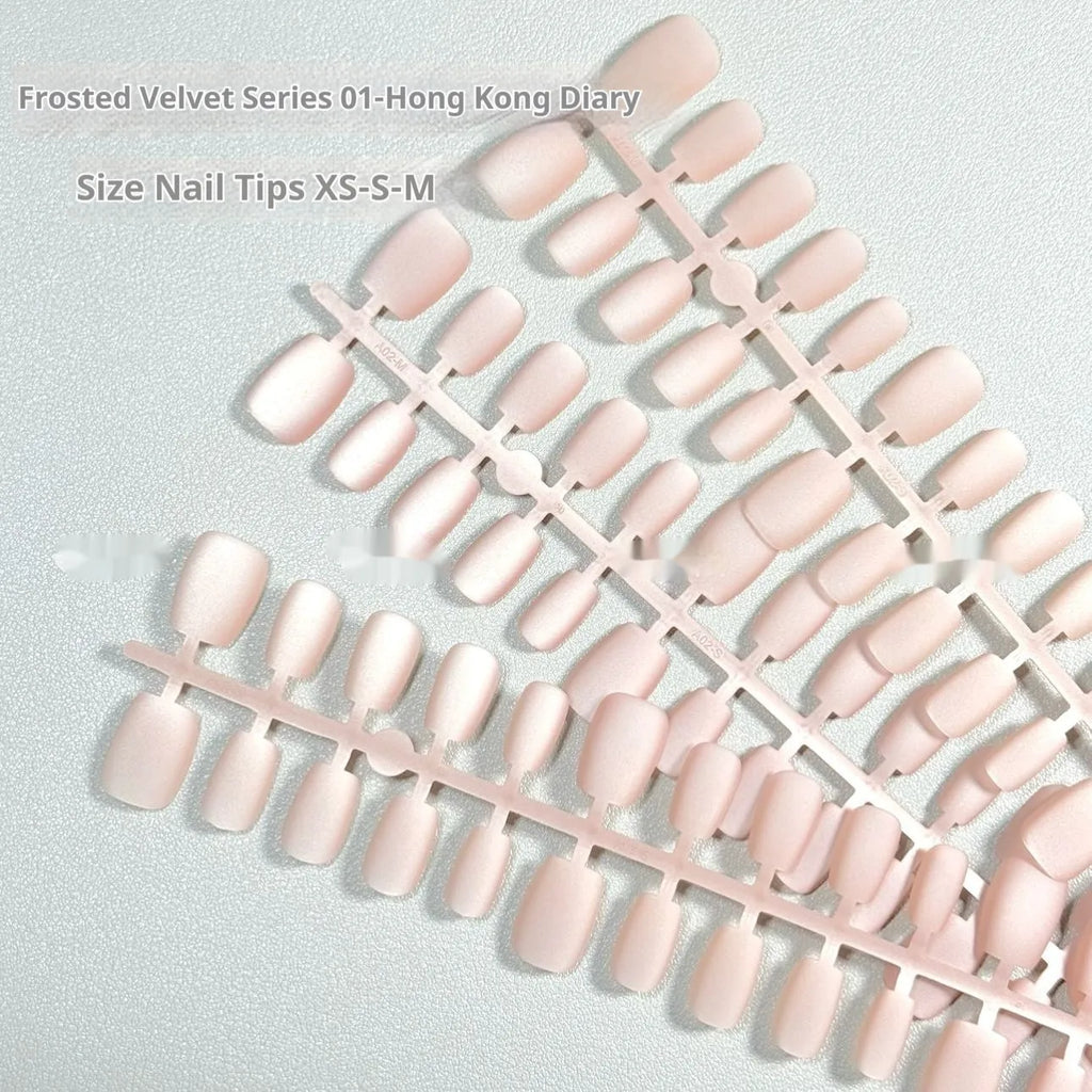 Frosted velvet Cat's Eye effect nail wraps in short ladder sizes XS, S, and M on a manicured hand.
