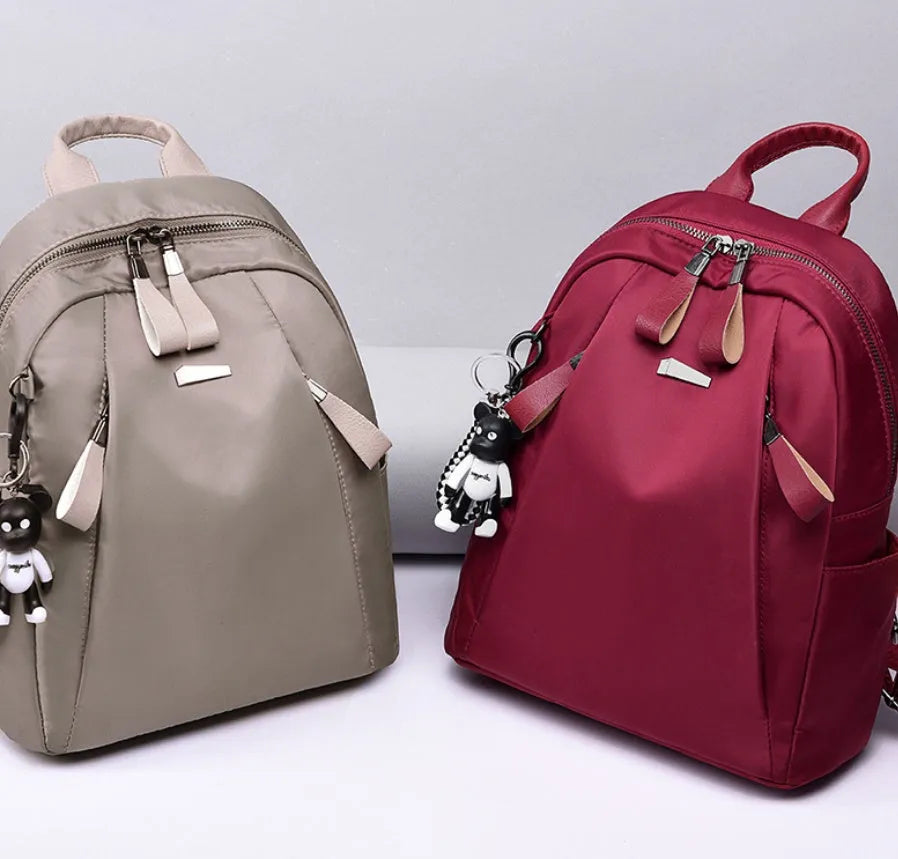 Medium grey Oxford cloth rucksack with double shoulder straps and front digging pocket.