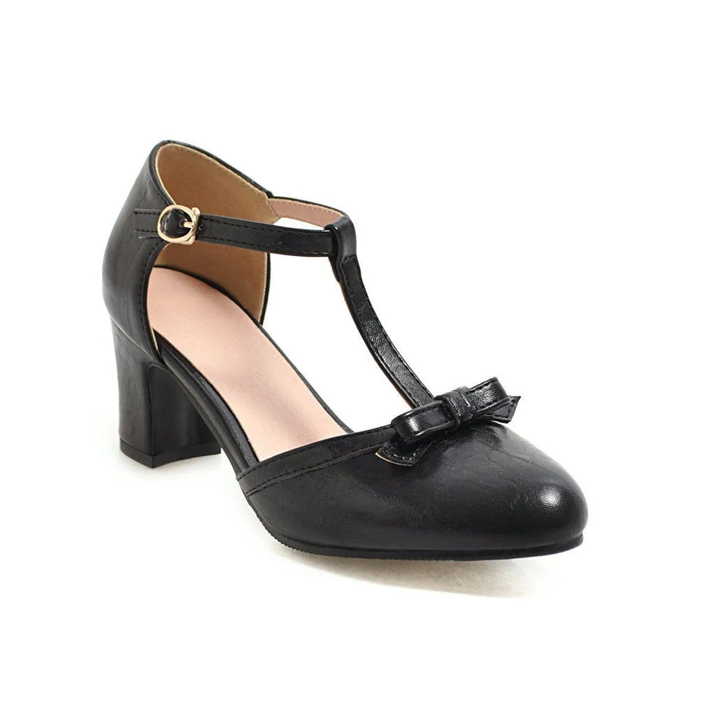 Women's apricot chunky heel sandals with a bow detail and adjustable buckle strap.