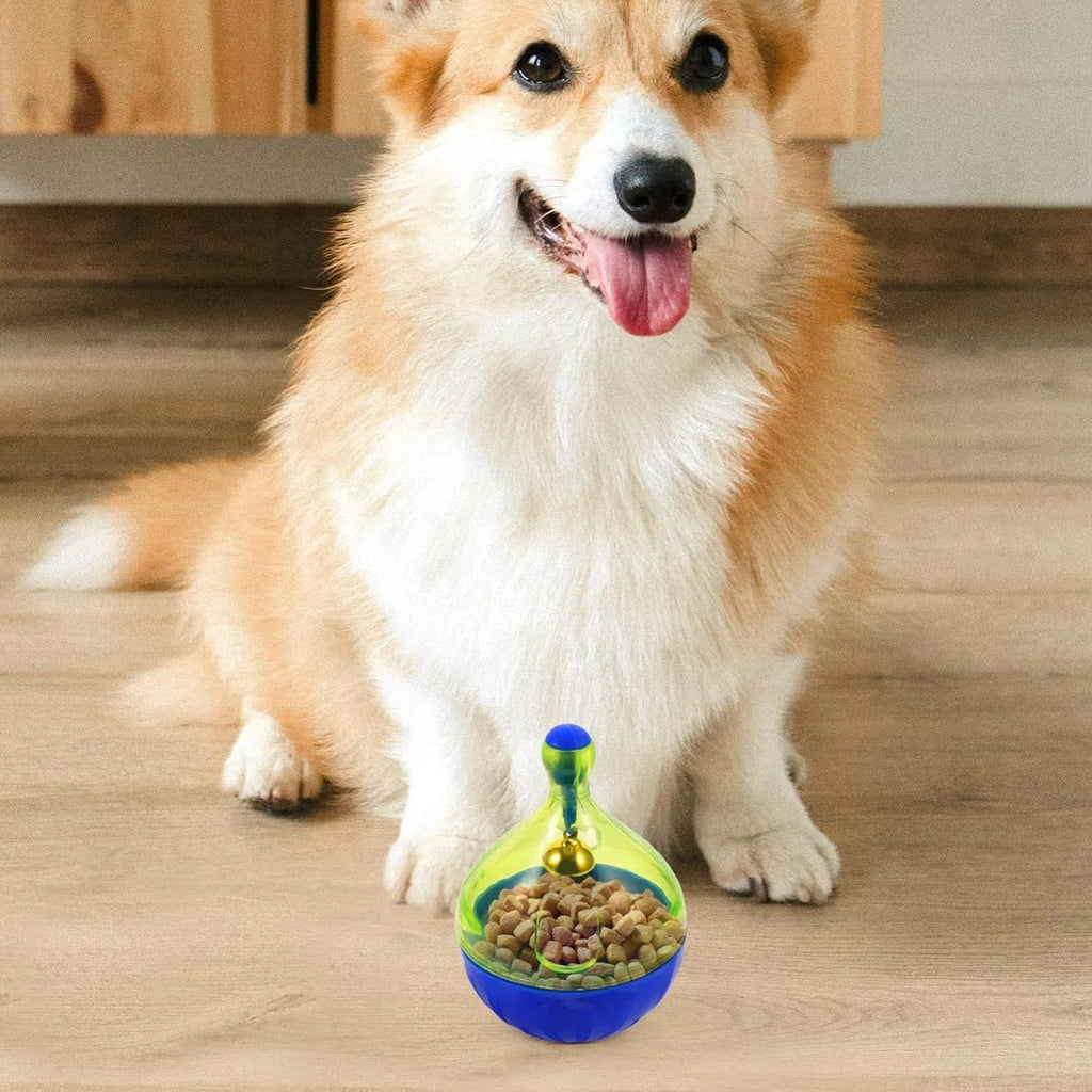 Blue and white tumbler-shaped dog and cat treat dispenser puzzle toy on a wooden floor.