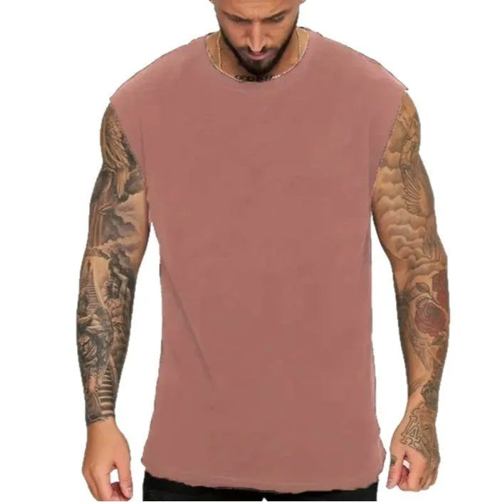 Men's loose fit solid colour cotton tank top on a hanger, shown in apricot colour.