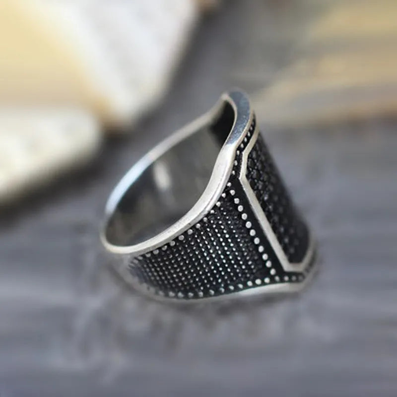 Black alloy ring with copper detailing and zircon accents shown in unisex design