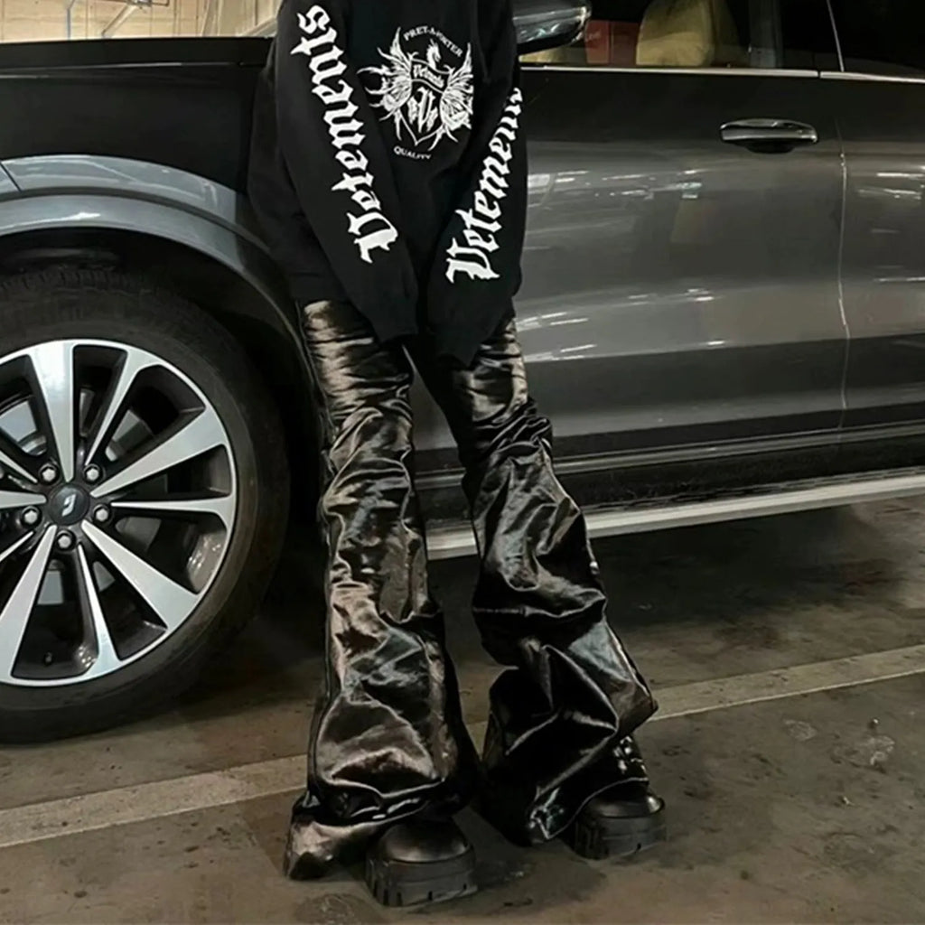 Black shiny patent leather skinny jeans with mid waist and straight leg on a model