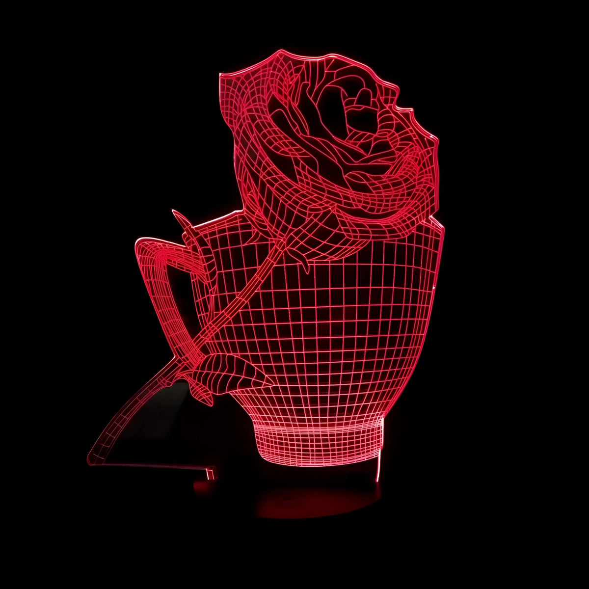 3D rose flower shaped night light with glowing LED colours on a black base, showing remote control.