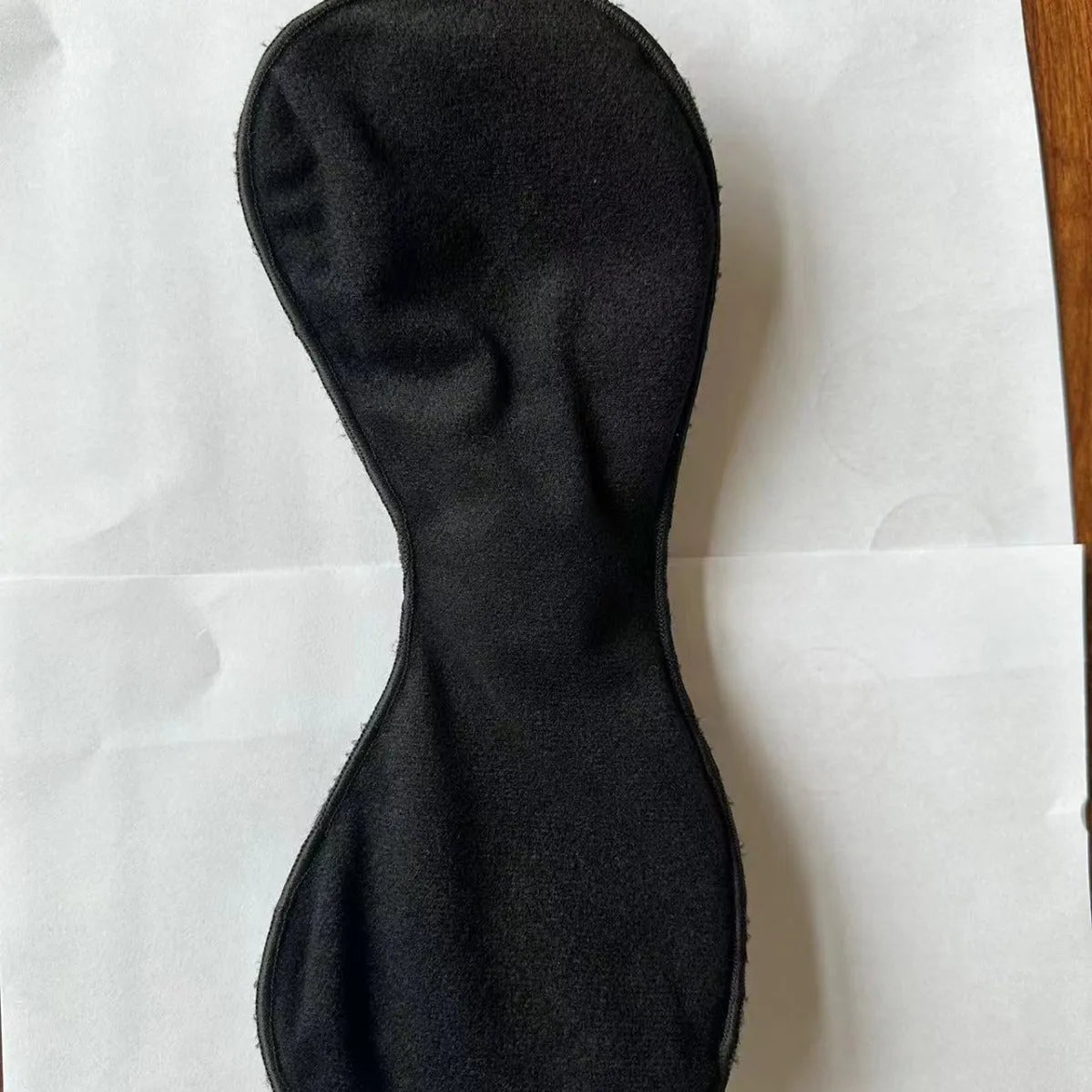 Black electric massage bra inner cushion accessory with 3-key control pad and chest stickers.