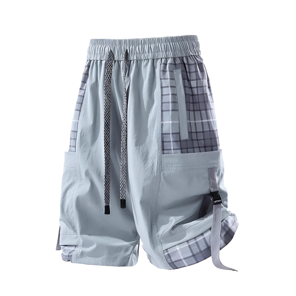 Men's black loose fit cargo shorts with plaid stitching detail on a grey background