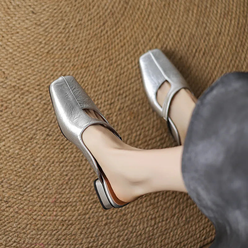 British style square toe leisure slippers in beige with a low heel and rubber sole.