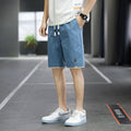 Korean style loose straight-leg casual shorts on a hanger in a khaki colour.