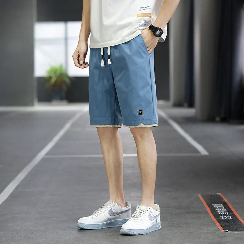 Korean style loose straight-leg casual shorts on a hanger in a khaki colour.