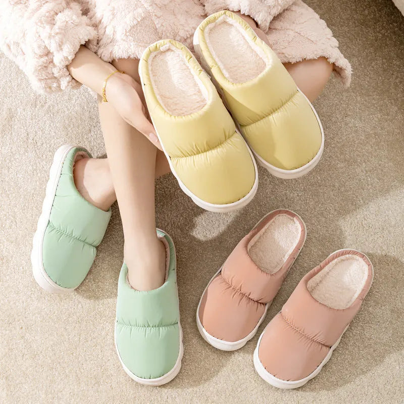 Blue down cotton slippers with a thick rubber sole and plush lining for indoor winter wear.