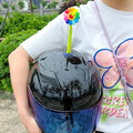 Yellow silicone sunflower helmet decoration with suction cup attachment swinging from motorcycle helmet