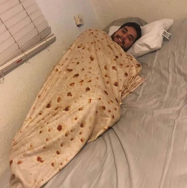 Round coral fleece burrito blanket with a food-themed print, shown folded.