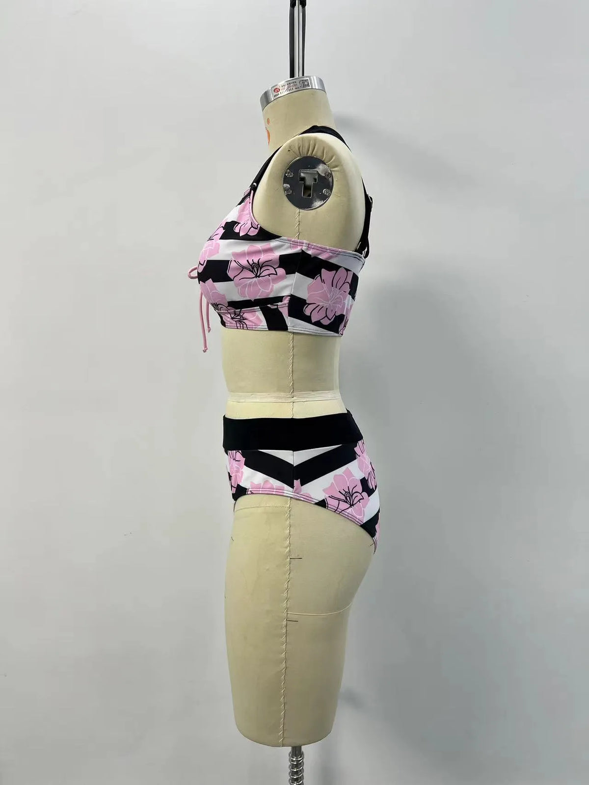 Black women's printed bikini with belly cover and split-leg design for swimming.