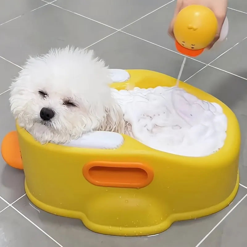 Blue PVC duck-shaped bathtub for washing a small dog, shown on a bathroom floor.