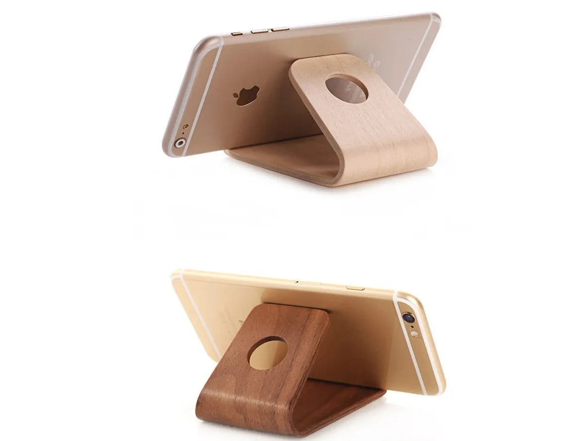 A wooden phone stand in a bracket design holding an iPhone, shown in walnut and white maple finishes.