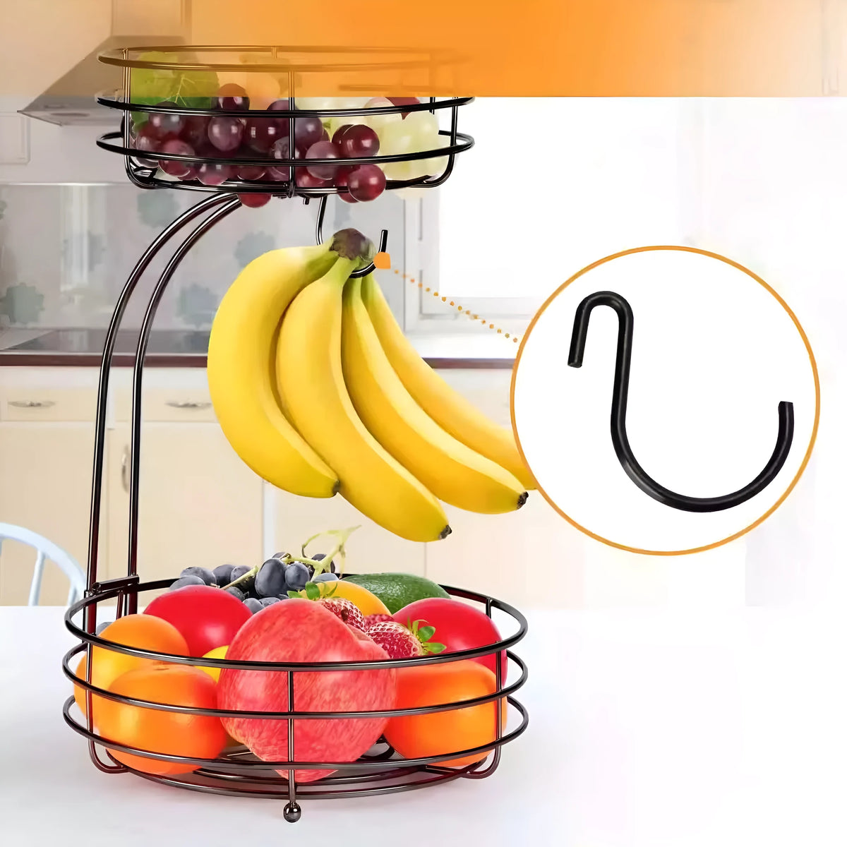 Double-tier black wrought iron fruit basket filled with assorted fruits on a countertop