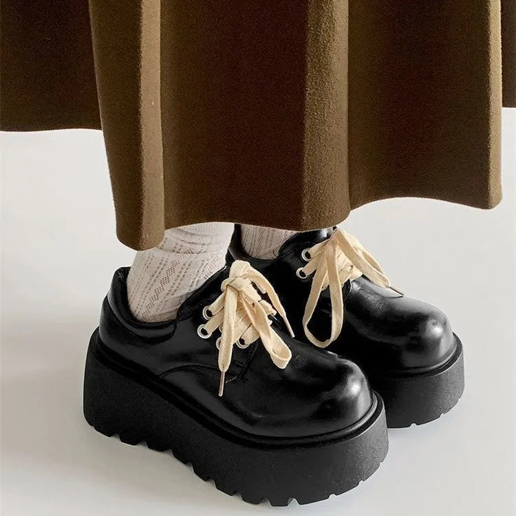 Matte black women's lace-up buckle boots with a thick sole and 6-8cm chunky heel on a white background.