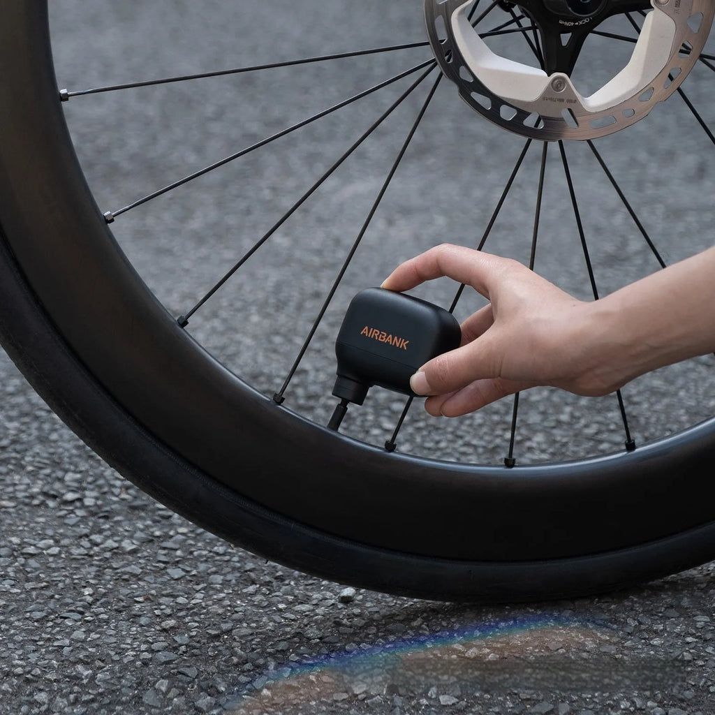 Black mini electric bike pump with digital display and USB charging port