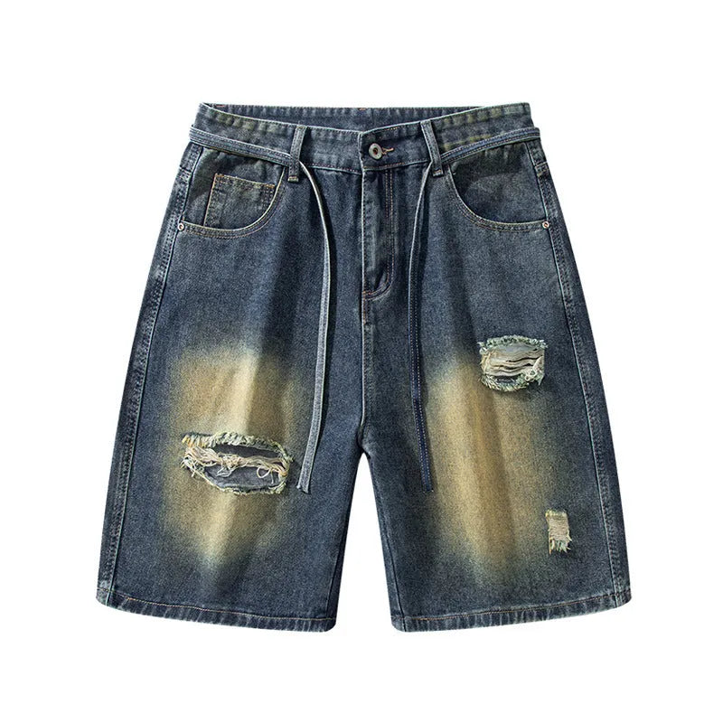 Man's retro blue loose fit jeans with ripped detailing on knees and thighs.
