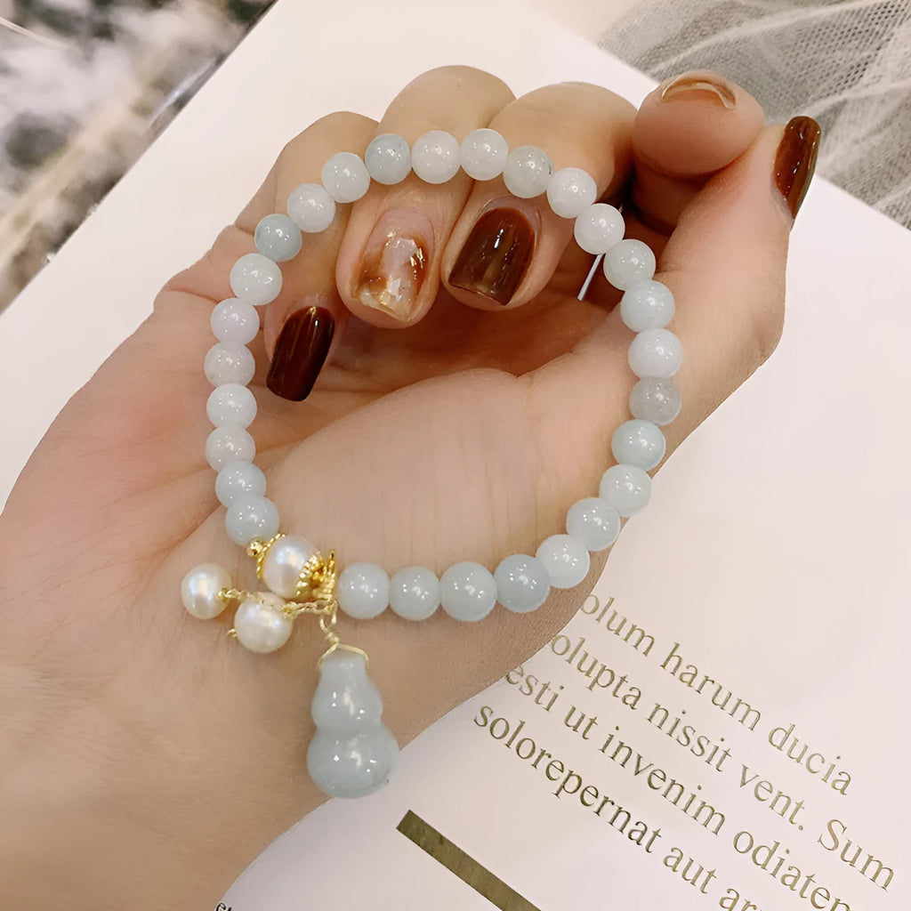 Chinese style jade bracelet with gourd design featuring natural emerald jade ins material.