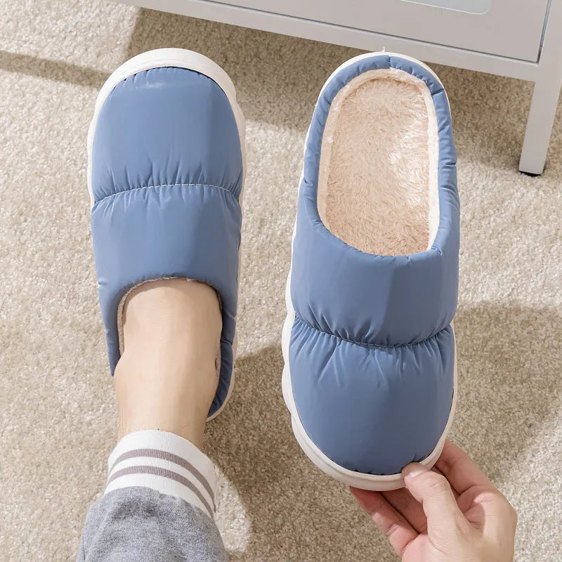 Blue down cotton slippers with a thick rubber sole and plush lining for indoor winter wear.