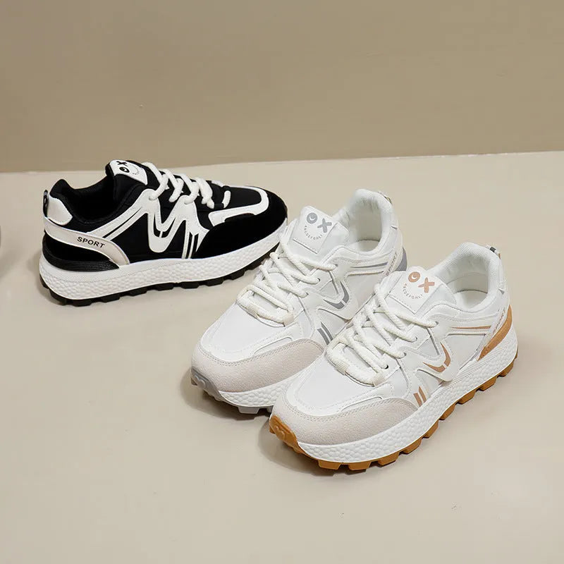 Women's black platform casual sports shoes with flat heel and white lace-up front closure on a neutral background.