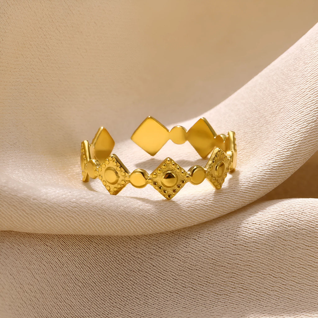 Golden diamond coloured titanium steel geometric women's ring on display