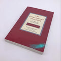 The Intelligent Investor paperback book by Benjamin Graham showing financial investment cover