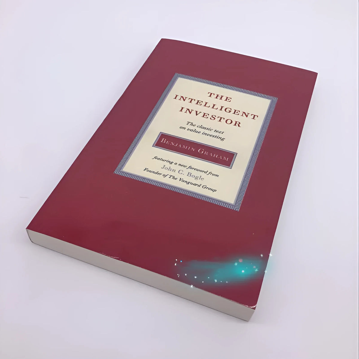 The Intelligent Investor paperback book by Benjamin Graham showing financial investment cover
