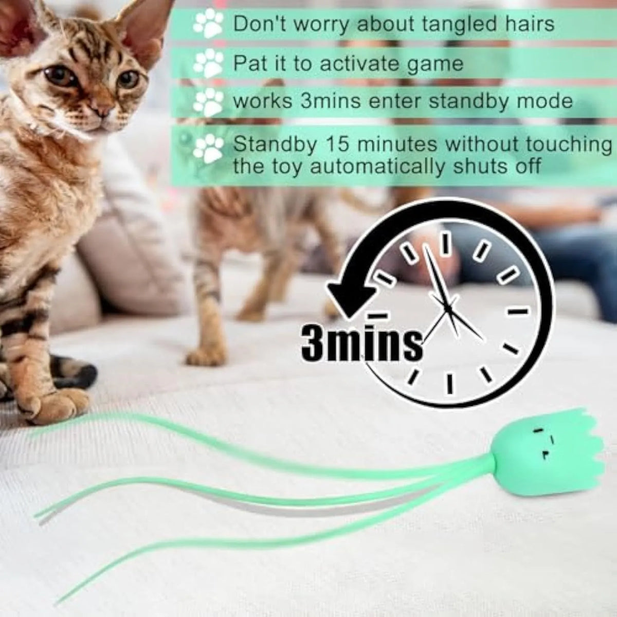 Green automatic cat toy with swinging silicone tails on a wooden floor.