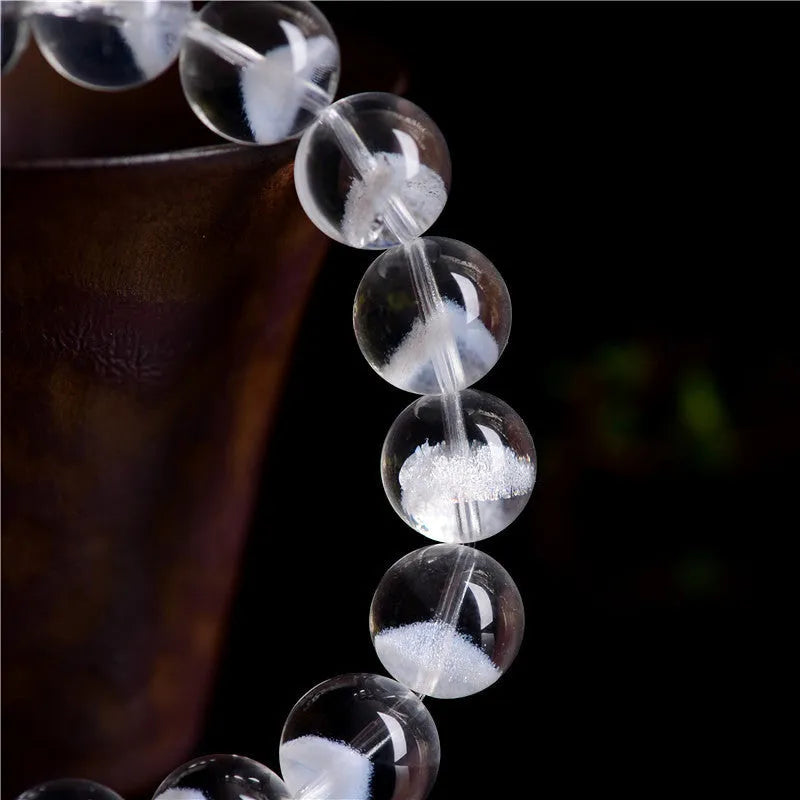 Women's natural white crystal ghost pyramid bracelet with Ruyi design on a model's wrist