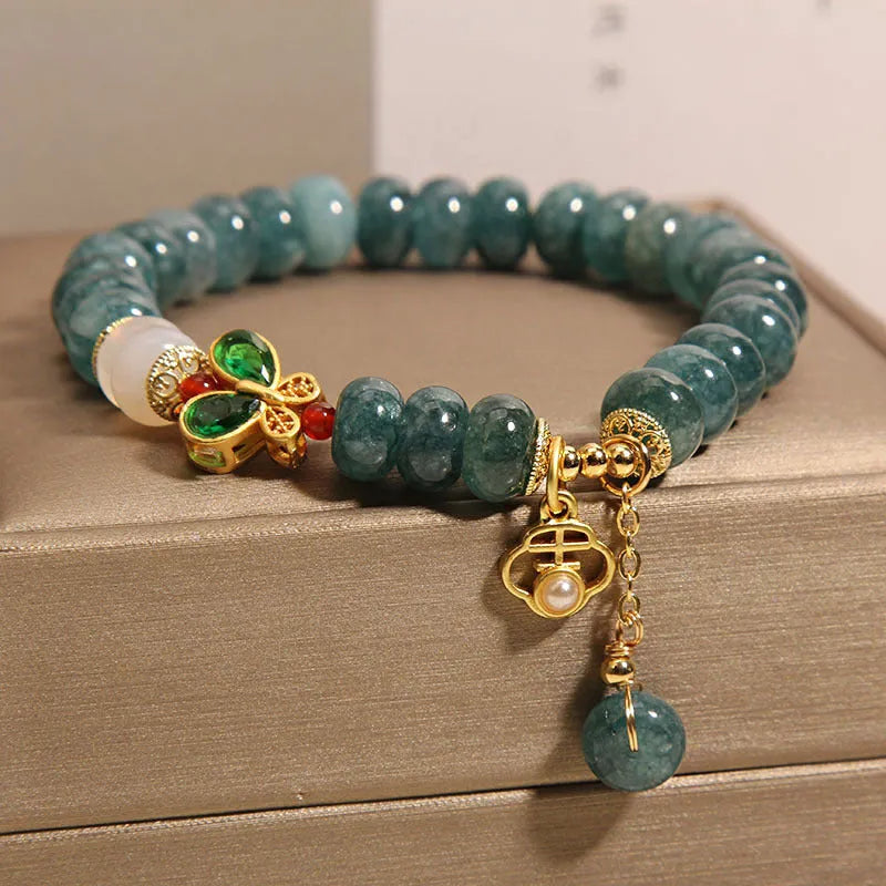 Blue water jade abacus bead crystal bracelet with butterfly charm and white agate beads