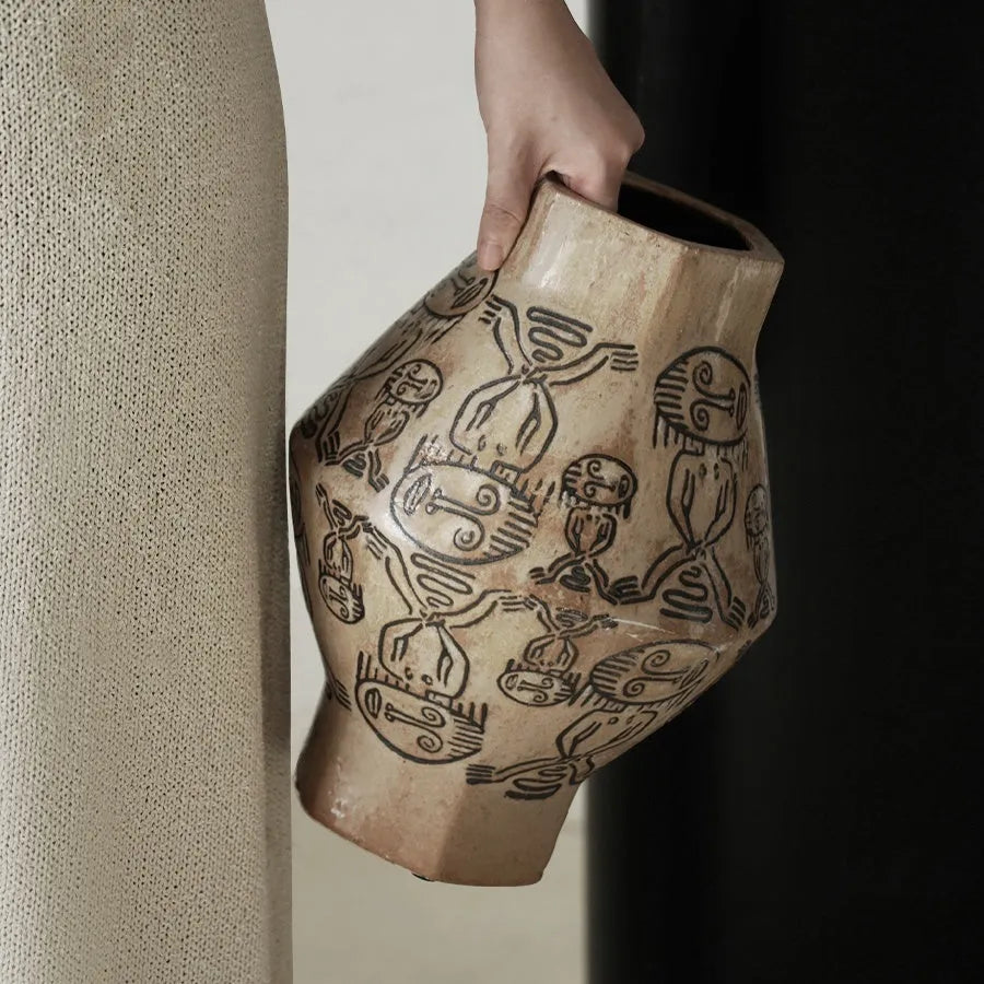 Hand-painted ceramic cylindrical vase with carved religious patterns in tribal totem flower design