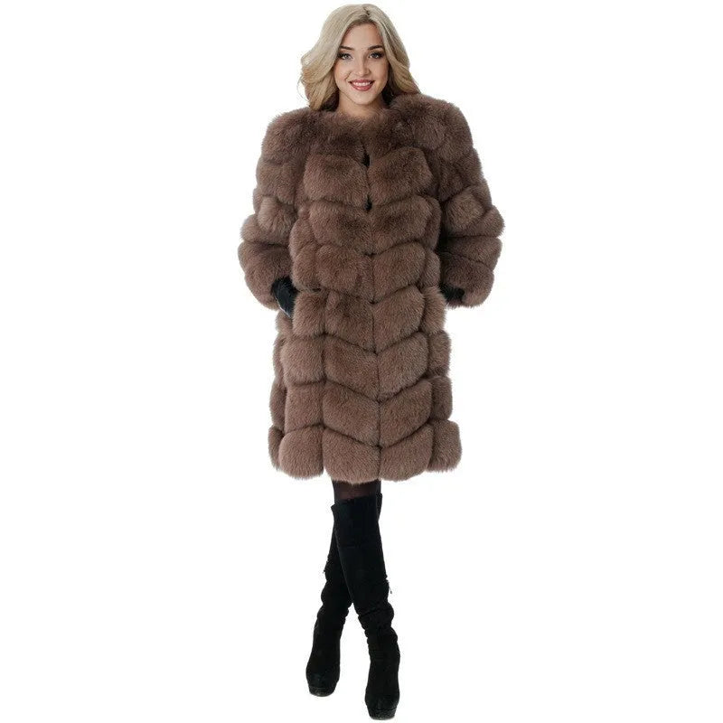 Women's long artificial fur coat in a choice of five colours, shown in a commute style setting.