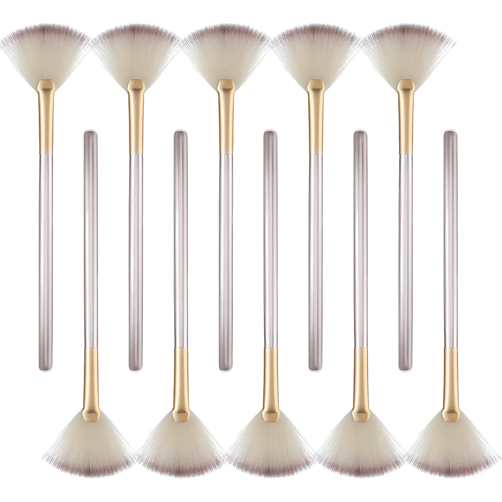 Ten champagne-finished facial fan brushes with acrylic handles and protective covers.