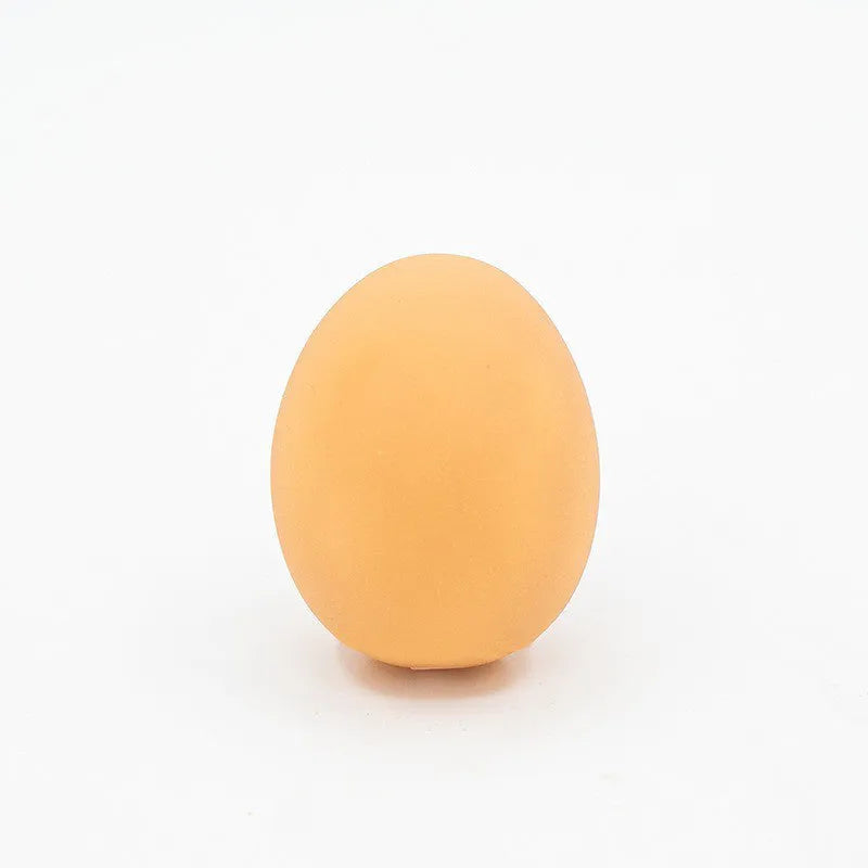 Yellow egg-shaped dog teeth cleaning toy with textured rubber surface for dental care